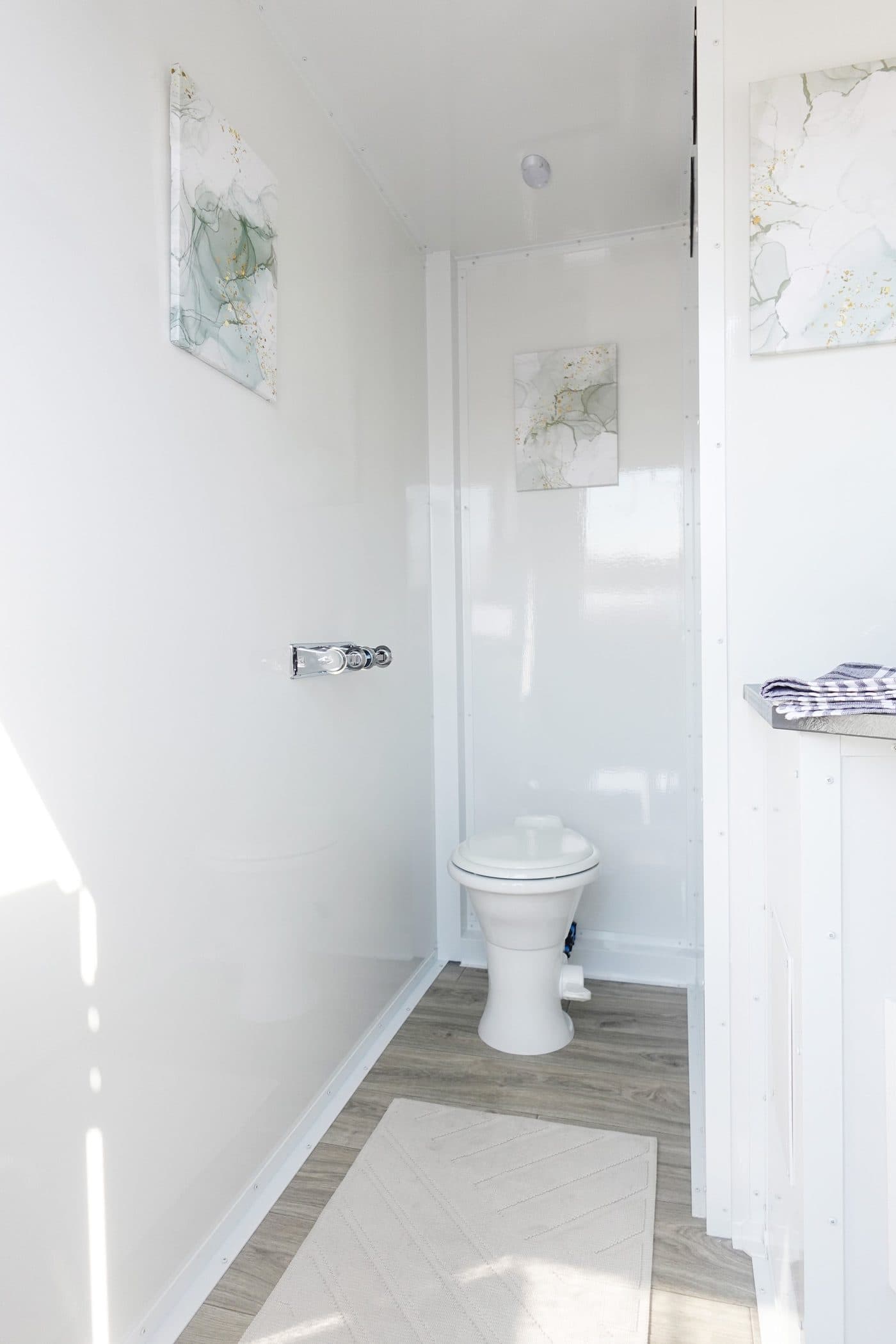 Upgraded stall in the seven-station luxury restroom trailer with decorative flooring and full-length mirror