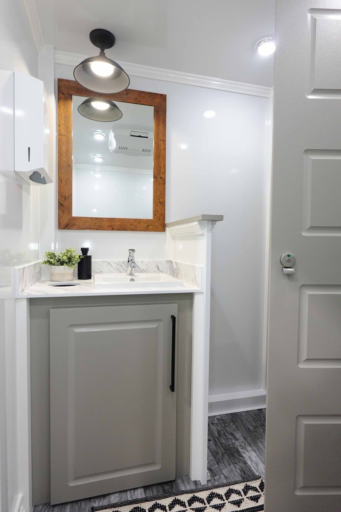 Private stall doors inside a climate-controlled luxury restroom trailer