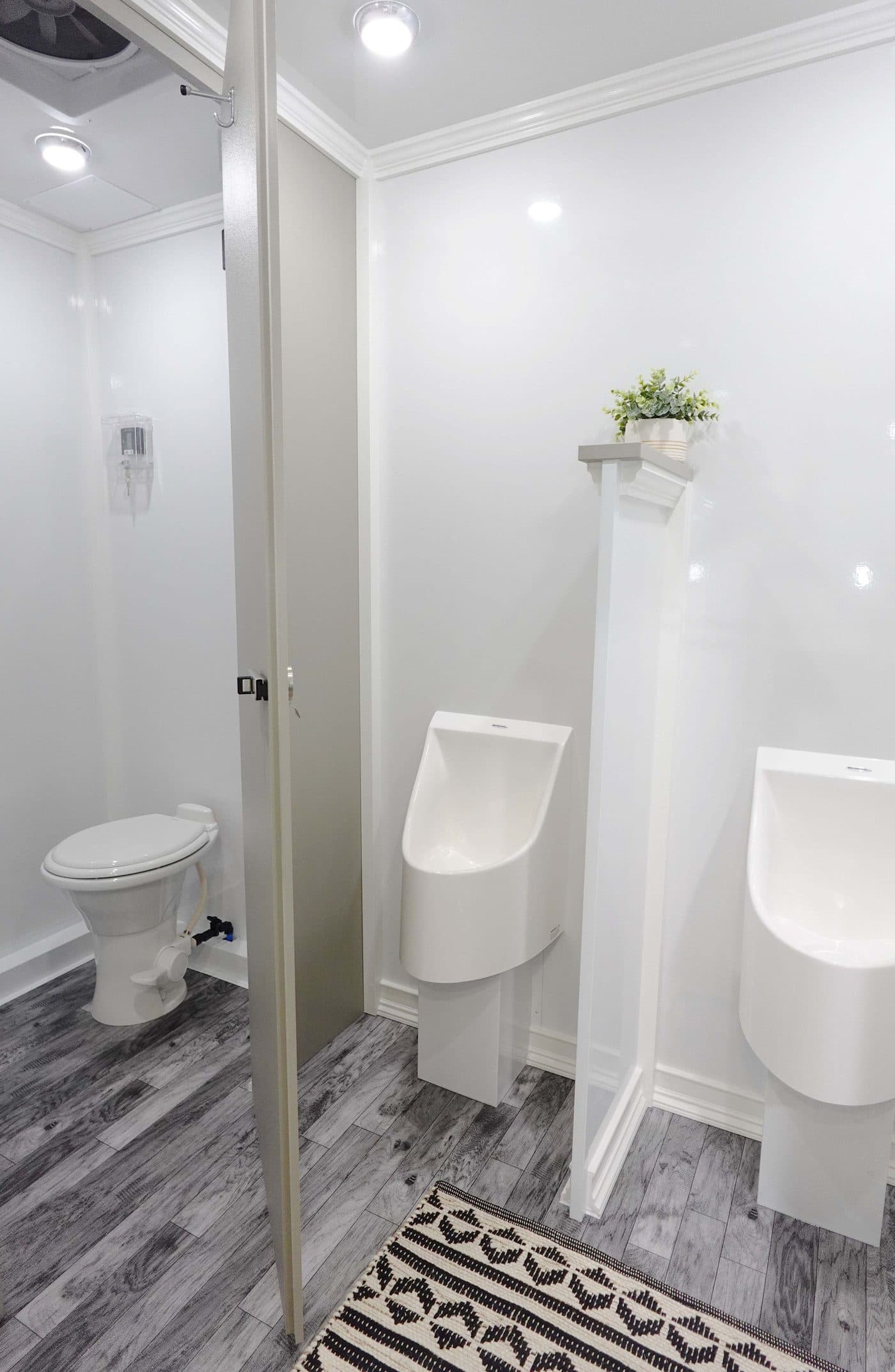 Close detail of the vanity, mirror, and fixtures inside a Trailer Bash Events restroom trailer