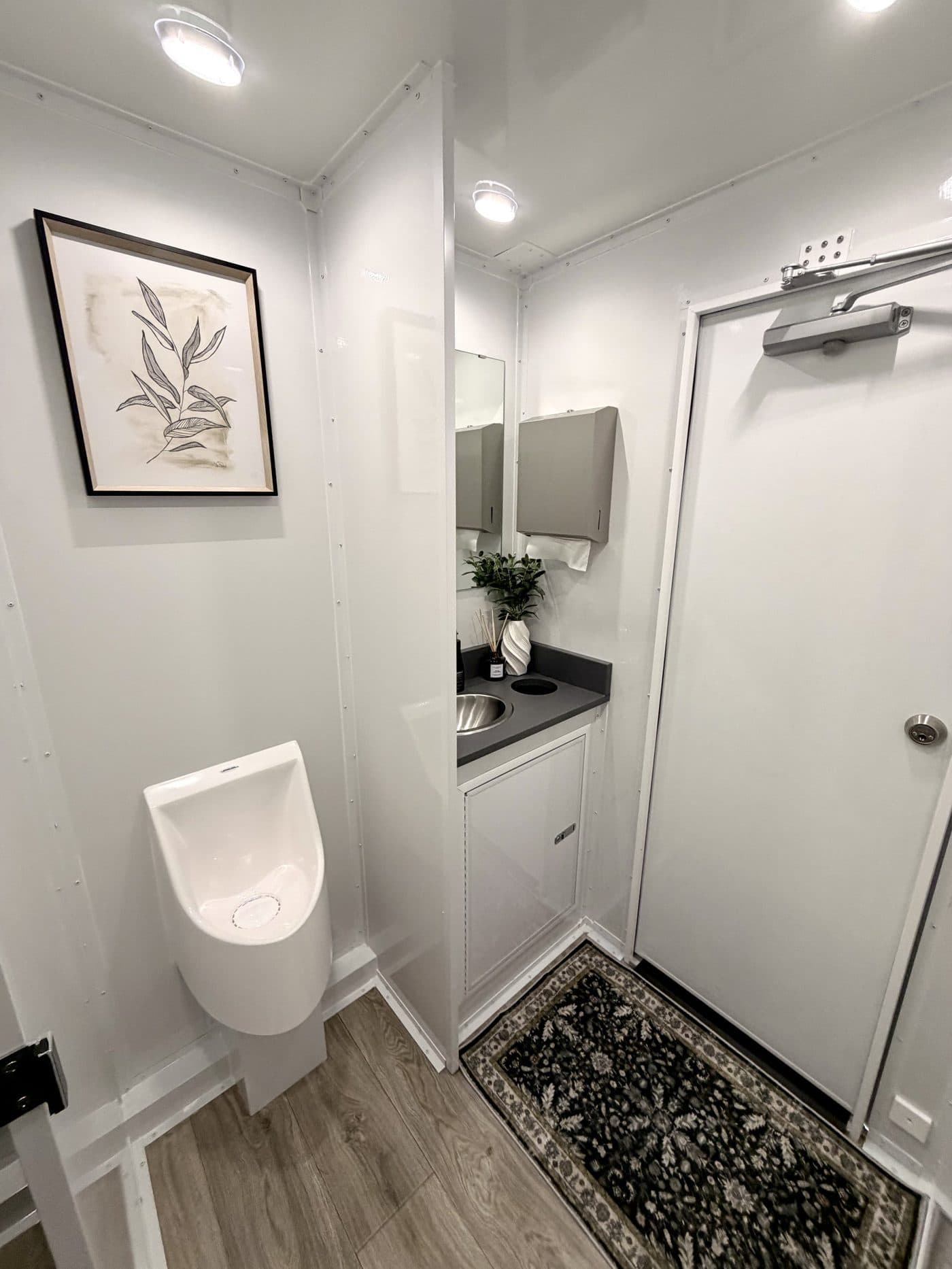 Women's stall inside a Trailer Bash Events restroom trailer, clean and fully stocked for guests